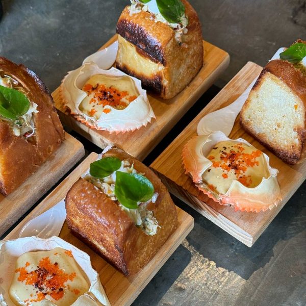 A plated mud crab sando made with Sienna brioche, topped with kamias hollandaise and coconut gelée, served as a modern take on Negrense flavors at Sauma Farm, Bar & Kitchen. 