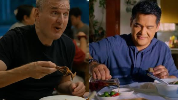 Phil Rosenthal and Jiggy Manicad sit side by side in separate frames, each digging into plates of Filipino food—representing the contrasting storytelling styles of Somebody Feed Phil Manila episode and I Love Filipino.