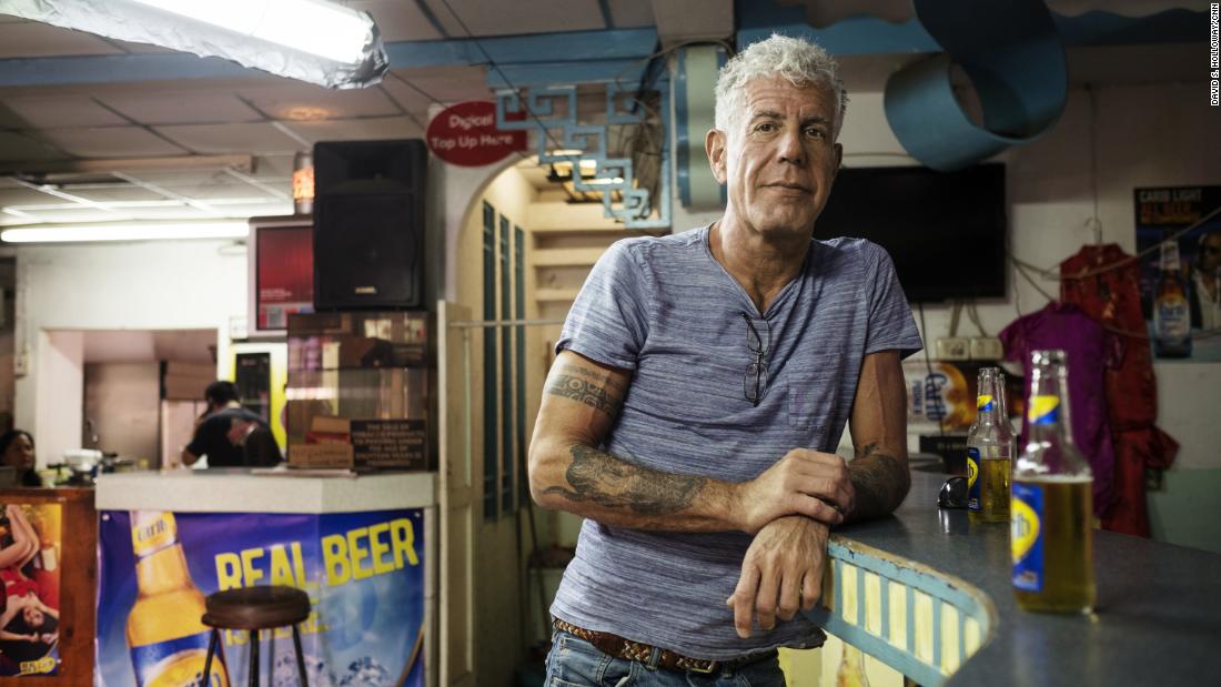 “Anthony Bourdain stands alone at a bar, looking contemplative. The photo honors his 7th death anniversary and highlights the importance of men’s mental health in the Philippines.”