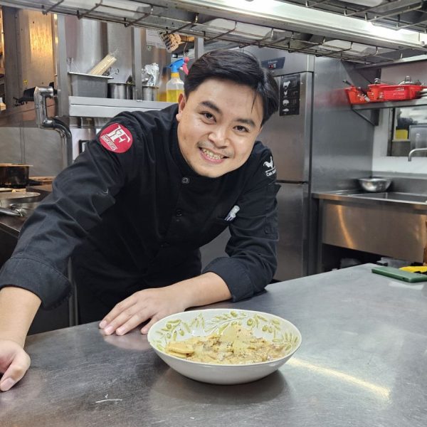 Chef Francis Lacson in the kitchen, carefully plating rigatoni with truffle sauce at Francesco’s San Juan Italian restaurant.