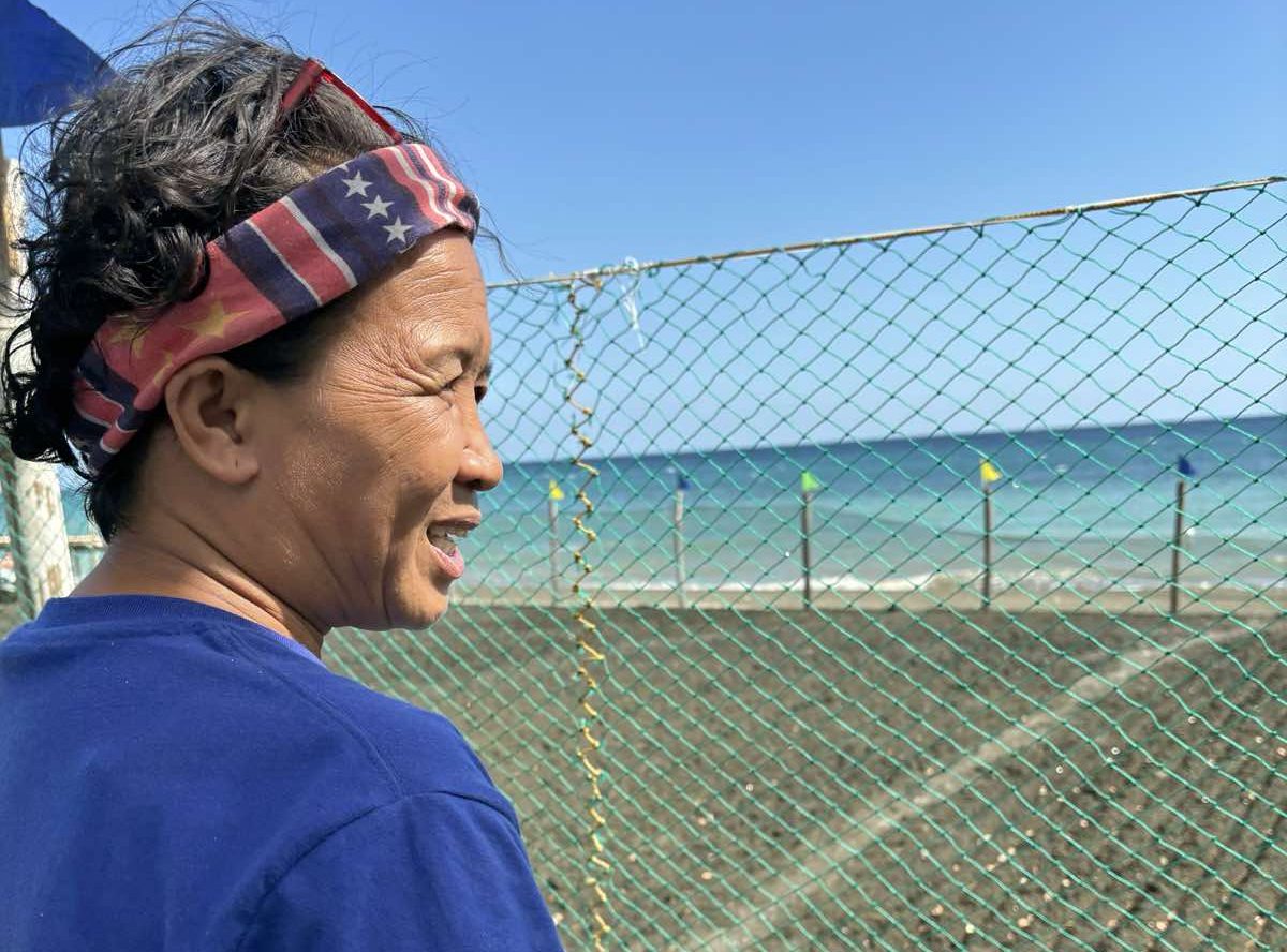 Lorlie Paguntalan Noblezada overlooking sandbeds along the Barangay De Paul shoreline in Miag-ao, preparing for the next harvest of Miag-ao artisanal sea salt, symbolizing hope and tradition.