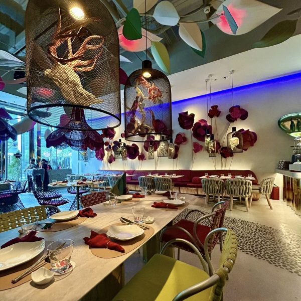 Interior shot of Fable by Kenneth Cobonpue showing curved furniture, soft lighting, and decorative installations.