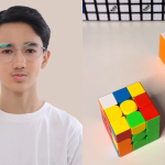 Portrait of Cebuano Rubik’s cube champion Leo Borromeo holding a cube, radiating quiet focus and Filipino pride
