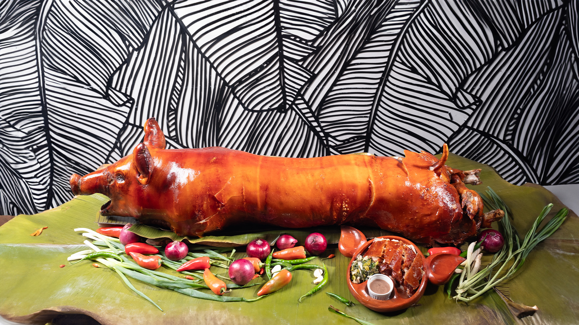 Whole Carcar-style lechon served at House of Lechon Cebu, featuring golden crispy skin and aromatic stuffing.