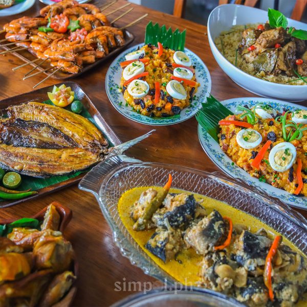 A colorful table filled with traditional Ilonggo festive dishes, showcasing the region’s spirit of generosity.