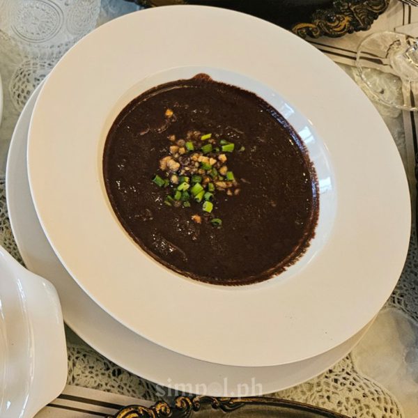 Dinuguan with puto manapla served on fine china in Agatona Mansion, 