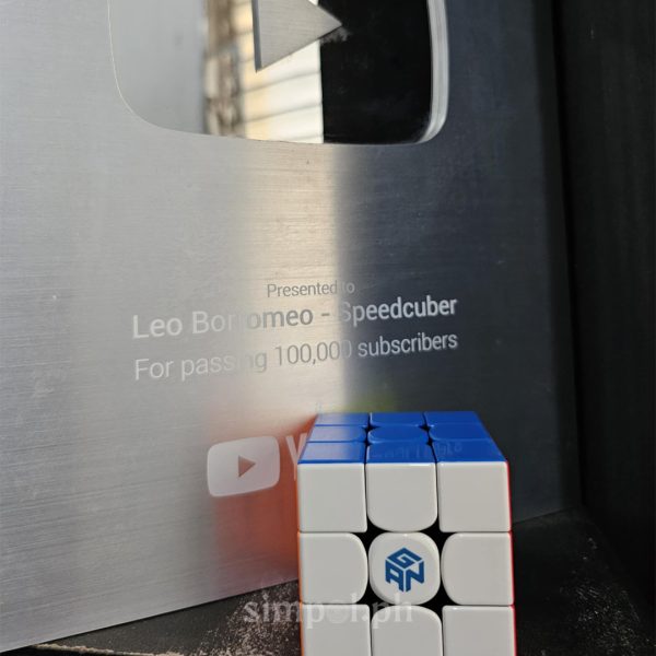 Leo Borromeo holding his YouTube Silver Creator Award and a GAN 16 speedcube—symbols of both his global reach and elite-level performance.