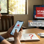online scam prevention PhilippinesA photograph shows a distressed Filipino woman seated at a wooden table, staring worryingly at a smartphone displaying a red "FRAUD DETECTED!" alert. Beside her phone is an open notebook detailing household expenses like "School Fees" and "Christmas," marked with a large red question mark, next to a small stack of Philippine peso bills. In the blurred background, a television screen prominently displays a news graphic with the text "SCAM ALERT: URGENT WARNING" and a banner reading "FILIPINOS AMONG MOST TARGETED IN SOUTHEAST ASIA."